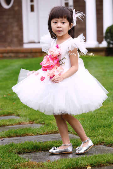 White tulle tutu dress with big floral bouquet. Matching headpiece included