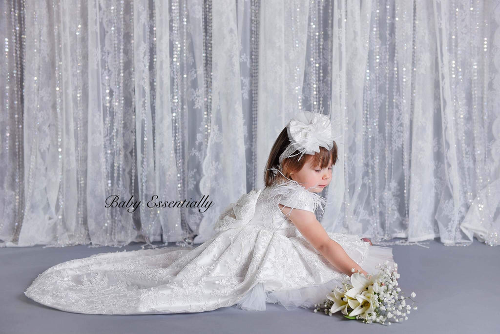 White high low, lace overlay dress. Front knee length. Bow head piece 