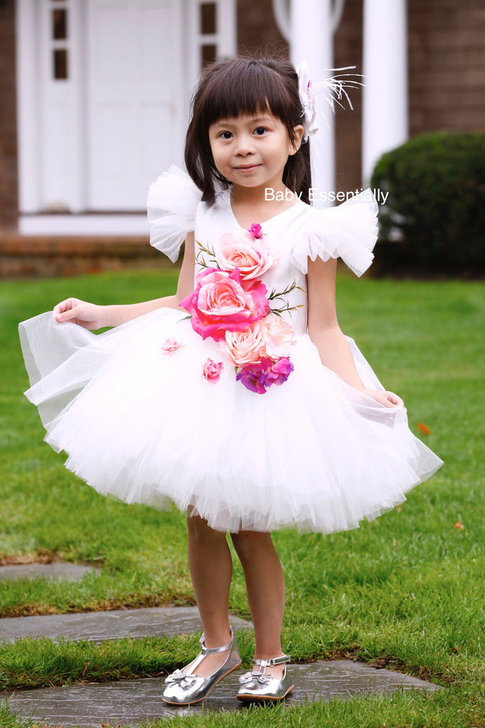 White tulle tutu dress with big floral bouquet. Matching headpiece included