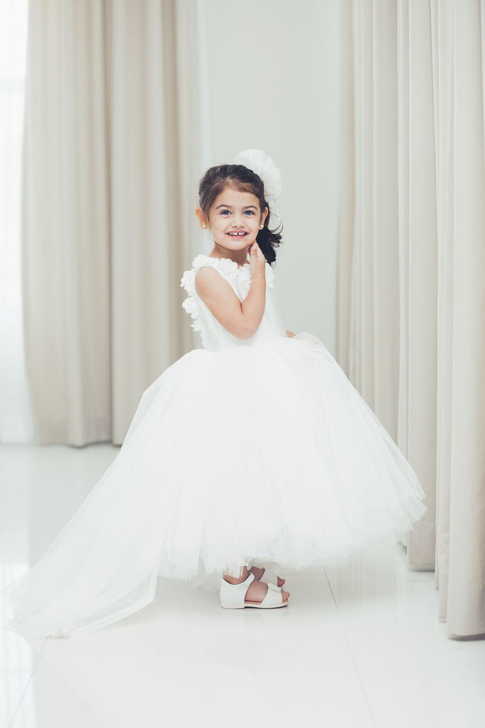 White dress, side view, white floral appliques, head vow shown