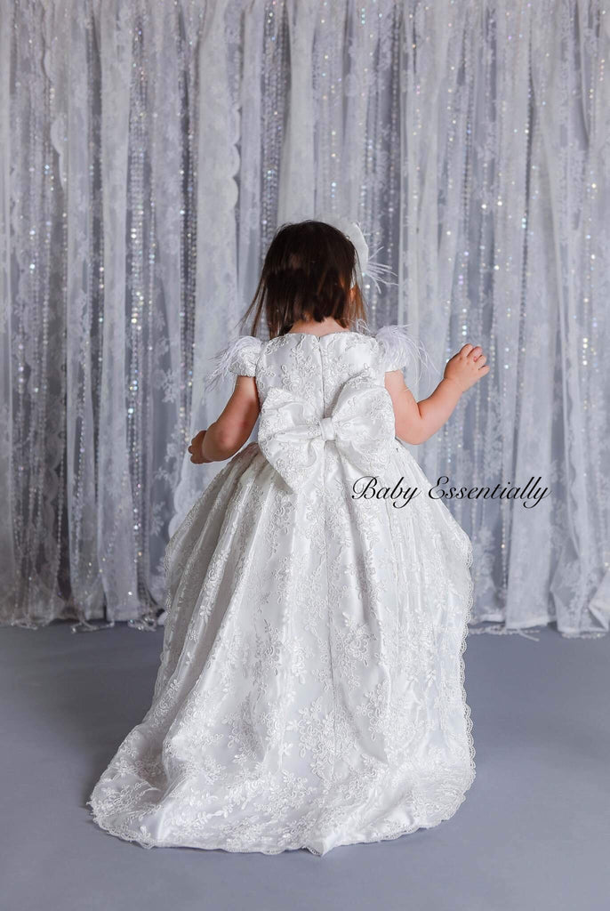 Back view White high low, lace overlay dress. Front knee length. Big bow on the back. 