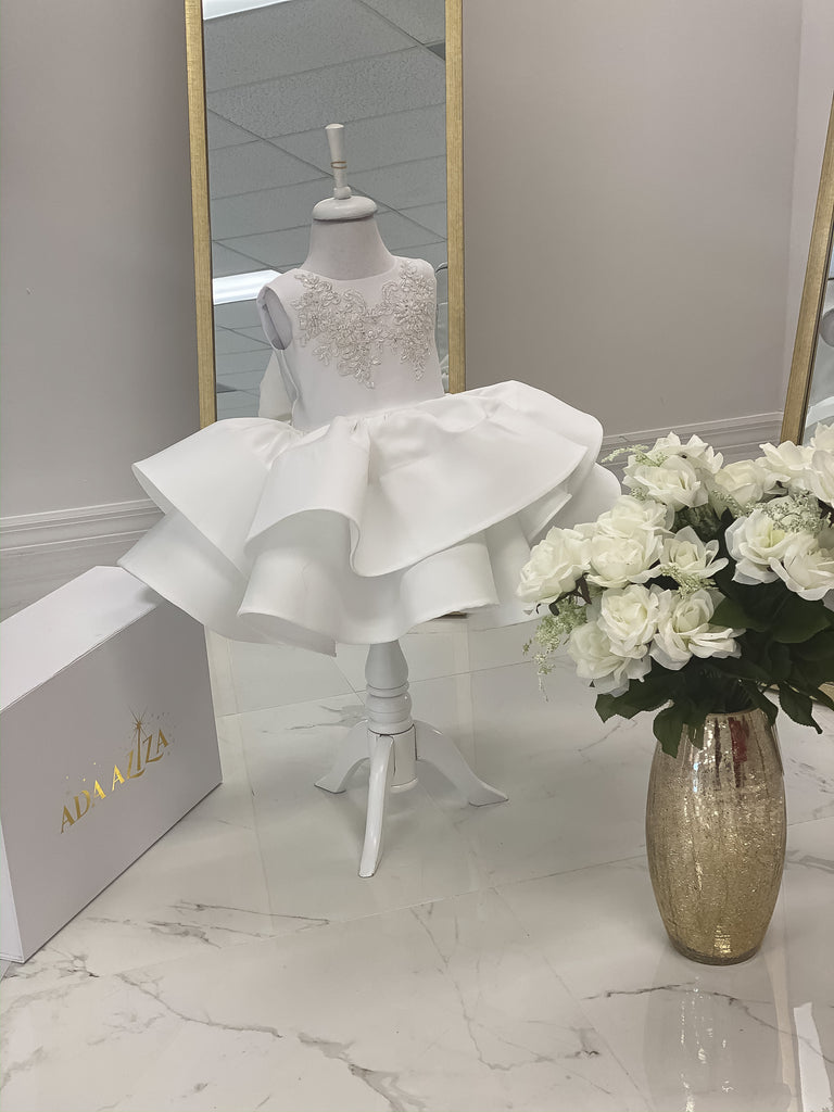 White sweet heart neck line mid length satin dress with double stair layers. Headpiece Included. Nodice has white Silver embroidery lace patch